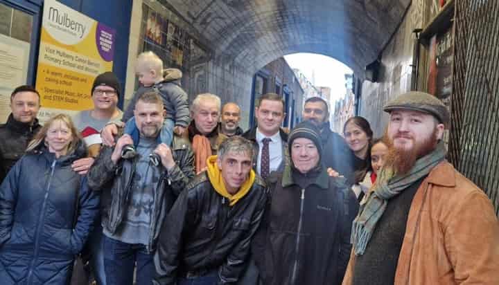 Tour group under an arched passage near a City primary school
