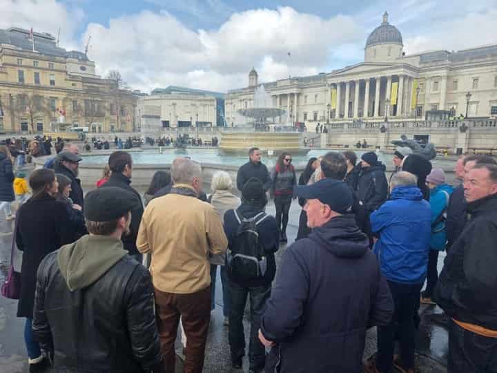 Tour group in Trafalgar Square with the National Gallery behind