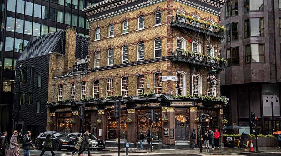 The Albert pub on a London street corner, with flower boxes on the balconies